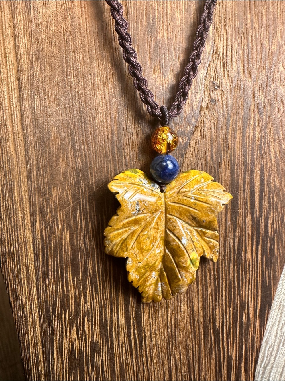 Yellow Ocean Jasper Leaf Carving Pendant Necklace on Brown Braided Rope - Picture 2 of 13